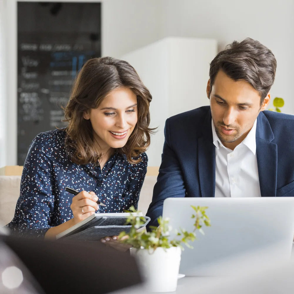 Two colleagues reviewing securities data together
